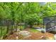 The serene backyard offers a lush, private space with mature trees and unique features such as a raised garden at 2904 Sprucewood Dr, Durham, NC 27707