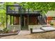 Inviting backyard featuring a covered patio, brick accents, and a stairway leading to an elevated deck at 2904 Sprucewood Dr, Durham, NC 27707