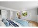 Bright bedroom featuring a blue bed set, hardwood floors, and a mirrored closet at 2904 Sprucewood Dr, Durham, NC 27707