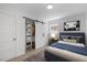 Cozy bedroom featuring a sliding barn door closet and modern design at 2904 Sprucewood Dr, Durham, NC 27707