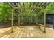 Outdoor deck with pergola and bench seating, a perfect spot to unwind and enjoy the surrounding green landscape at 2904 Sprucewood Dr, Durham, NC 27707