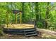 Spacious deck features a custom pergola, providing an ideal space for outdoor lounging and enjoying the natural surroundings at 2904 Sprucewood Dr, Durham, NC 27707