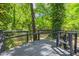 Wooden deck surrounded by lush greenery at 2904 Sprucewood Dr, Durham, NC 27707