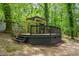 Elevated deck with a pergola that offers a private spot for outdoor relaxation surrounded by lush greenery at 2904 Sprucewood Dr, Durham, NC 27707