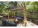 Outdoor deck showcases a pergola with string lights, comfortable seating and a warm fire pit, perfect for entertaining at 2904 Sprucewood Dr, Durham, NC 27707