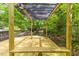 Relaxing deck with pergola features a built-in bench, creating a perfect outdoor retreat for peaceful enjoyment at 2904 Sprucewood Dr, Durham, NC 27707