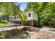 Two-story home with red brick and white siding surrounded by lush trees at 2904 Sprucewood Dr, Durham, NC 27707