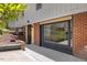 Home's red brick base is visible from a covered patio area with a black trimmed doorway at 2904 Sprucewood Dr, Durham, NC 27707