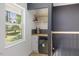 Hallway features a wine bar with modern finishes and an adjacent window at 2904 Sprucewood Dr, Durham, NC 27707