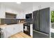 This modern kitchen features black stainless steel appliances and white cabinets, designed for a modern feel at 2904 Sprucewood Dr, Durham, NC 27707