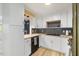 Modern kitchen boasts sleek white cabinets, wooden countertops, and stylish black hardware at 2904 Sprucewood Dr, Durham, NC 27707