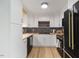 A well-appointed kitchen featuring white cabinetry, modern appliances, and a sleek design at 2904 Sprucewood Dr, Durham, NC 27707