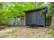 Modern shed with a dark exterior and lattice windows, adding a stylish and practical element to the backyard at 2904 Sprucewood Dr, Durham, NC 27707