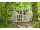 Outdoor shed offering extra storage with lattice design and surrounded by greenery at 2904 Sprucewood Dr, Durham, NC 27707