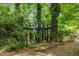 Treehouse with spiral stairs amidst dense foliage, providing a secluded and enchanting retreat at 2904 Sprucewood Dr, Durham, NC 27707