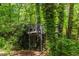 Elevated treehouse with spiral stairs surrounded by lush greenery, offering a unique and adventurous space at 2904 Sprucewood Dr, Durham, NC 27707
