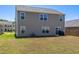 Back of house featuring large windows, a sliding glass door and spacious yard for recreation at 2923 Cullens Dr, Graham, NC 27253