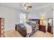 Cozy bedroom with plush carpeting, a ceiling fan, and a warm, inviting ambiance at 2923 Cullens Dr, Graham, NC 27253