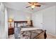 Comfortable bedroom showcasing warm lighting, plush carpeting and a ceiling fan at 2923 Cullens Dr, Graham, NC 27253