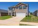 Inviting two-story home featuring a spacious driveway and well manicured lawn at 2923 Cullens Dr, Graham, NC 27253