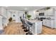 Well-equipped kitchen featuring a large island with seating, granite countertops, and stainless steel appliances at 2923 Cullens Dr, Graham, NC 27253