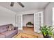 Comfortable living room featuring a couch, hardwood floors, and a view of an adjacent room through double doors at 2923 Cullens Dr, Graham, NC 27253