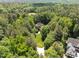 Aerial view of a home with a long driveway and mature trees surrounding the property at 3203 Rugby Rd, Durham, NC 27707