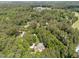 Aerial view of a home among mature trees near a golf course and other community buildings at 3203 Rugby Rd, Durham, NC 27707