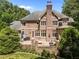 A brick home featuring a large, raised patio perfect for outdoor entertaining and relaxation at 3203 Rugby Rd, Durham, NC 27707