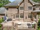 A brick home featuring a large, raised patio perfect for outdoor entertaining and relaxation at 3203 Rugby Rd, Durham, NC 27707