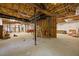 Basement with exposed duct work and ceiling, unfinished concrete floors, ladder, and building material at 3203 Rugby Rd, Durham, NC 27707