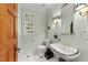 Elegant powder room with pedestal sink, decorative mirror, and natural light at 3203 Rugby Rd, Durham, NC 27707
