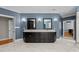 Spacious bathroom with dual sink vanity, blue walls, and marble tile flooring at 3203 Rugby Rd, Durham, NC 27707