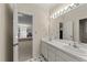 Bathroom featuring dual sinks, a large mirror, and an entryway to another room at 3203 Rugby Rd, Durham, NC 27707