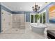 Luxurious bathroom featuring a standalone tub, chandelier, and a spacious glass-enclosed shower at 3203 Rugby Rd, Durham, NC 27707