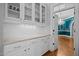 Butler's pantry with white cabinets, subway tile backsplash, and elegant granite countertops at 3203 Rugby Rd, Durham, NC 27707