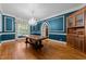 Formal dining room with hardwood floors, chandelier, wainscoting and large table perfect for entertaining at 3203 Rugby Rd, Durham, NC 27707