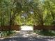 A long, tree-lined driveway leads to a beautiful home, offering privacy and curb appeal at 3203 Rugby Rd, Durham, NC 27707