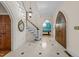 Grand foyer featuring tiled floors, staircase, and decorative front door with view to dining room beyond at 3203 Rugby Rd, Durham, NC 27707