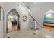 Elegant foyer featuring tiled floors, staircase, and arched doorways with view to rooms beyond at 3203 Rugby Rd, Durham, NC 27707