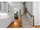 Hallway and stairs, and view of dining room, offering easy access to all areas of the home at 3203 Rugby Rd, Durham, NC 27707