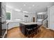 Open kitchen featuring white cabinetry, granite countertops, and a central island with seating at 3203 Rugby Rd, Durham, NC 27707
