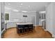 Spacious kitchen with white cabinetry, granite countertops, and a large center island with seating at 3203 Rugby Rd, Durham, NC 27707
