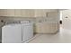 Spacious laundry room with cabinetry, countertop, sink, washer, and dryer at 3203 Rugby Rd, Durham, NC 27707