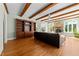 Comfortable living room featuring a stone fireplace, built-in bookcase, and hardwood floors at 3203 Rugby Rd, Durham, NC 27707