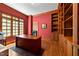 Bright office featuring custom built-in shelving, a large window, and hardwood floors at 3203 Rugby Rd, Durham, NC 27707