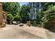Outdoor patio with seating area, lush greenery, and a view of the backyard at 3203 Rugby Rd, Durham, NC 27707