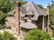 Brick home with multi-pane windows, and a spacious outdoor patio for relaxing or entertaining at 3203 Rugby Rd, Durham, NC 27707