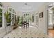 Bright sunroom with tiled floors, many windows, and views of the landscaped exterior at 3203 Rugby Rd, Durham, NC 27707