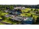 Aerial view of community tennis and pickleball courts with a clubhouse and golf course in the background at 3203 Rugby Rd, Durham, NC 27707